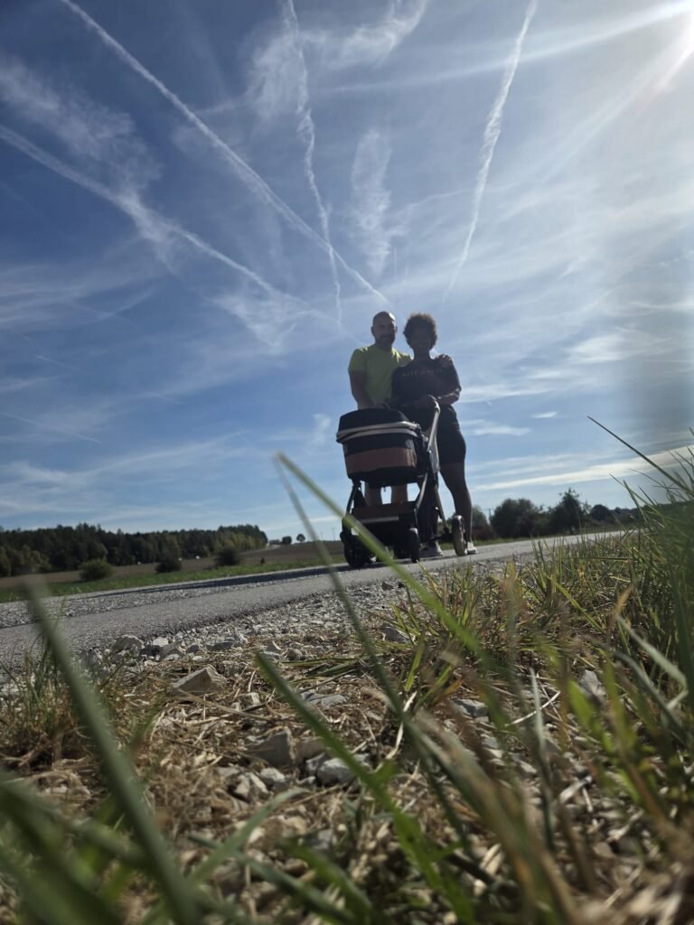Noé Serrano y Diana paseando con Carlota en el carrito por un camino rural cerca de Hemau, Alemania